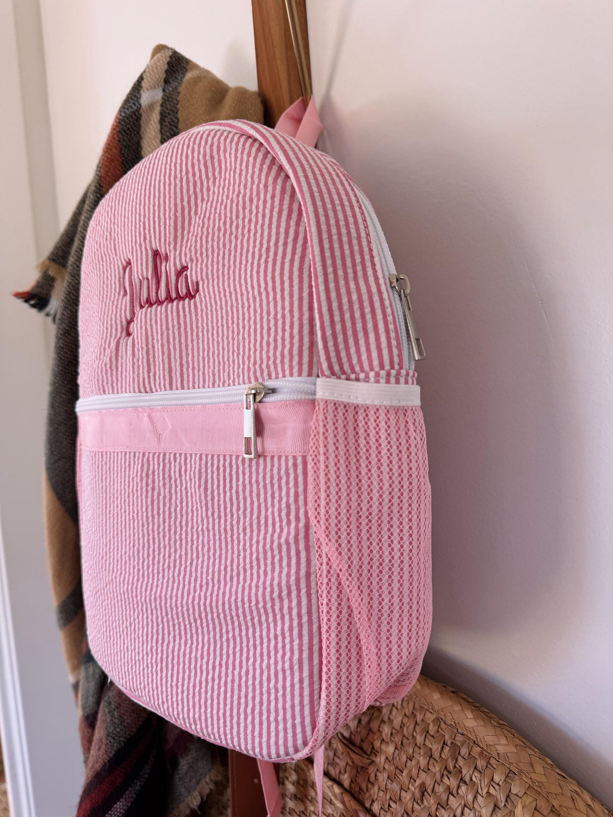 Embroidered name detail on a toddler backpack