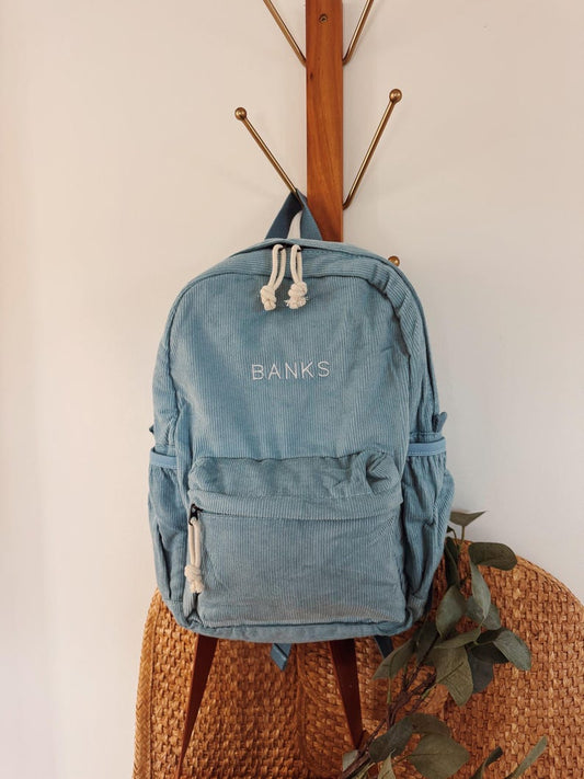 Personalized toddler corduroy backpack in pink with custom embroidered name and tag — kids school or daycare bag