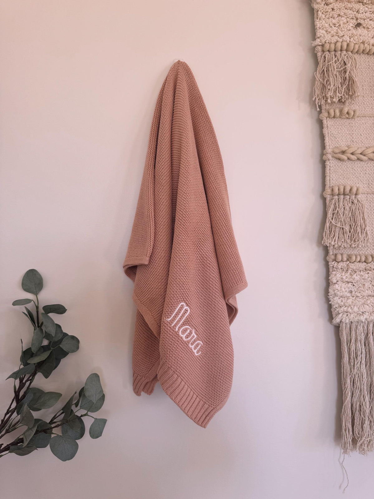 Organic cotton knit baby blanket styled in a nursery