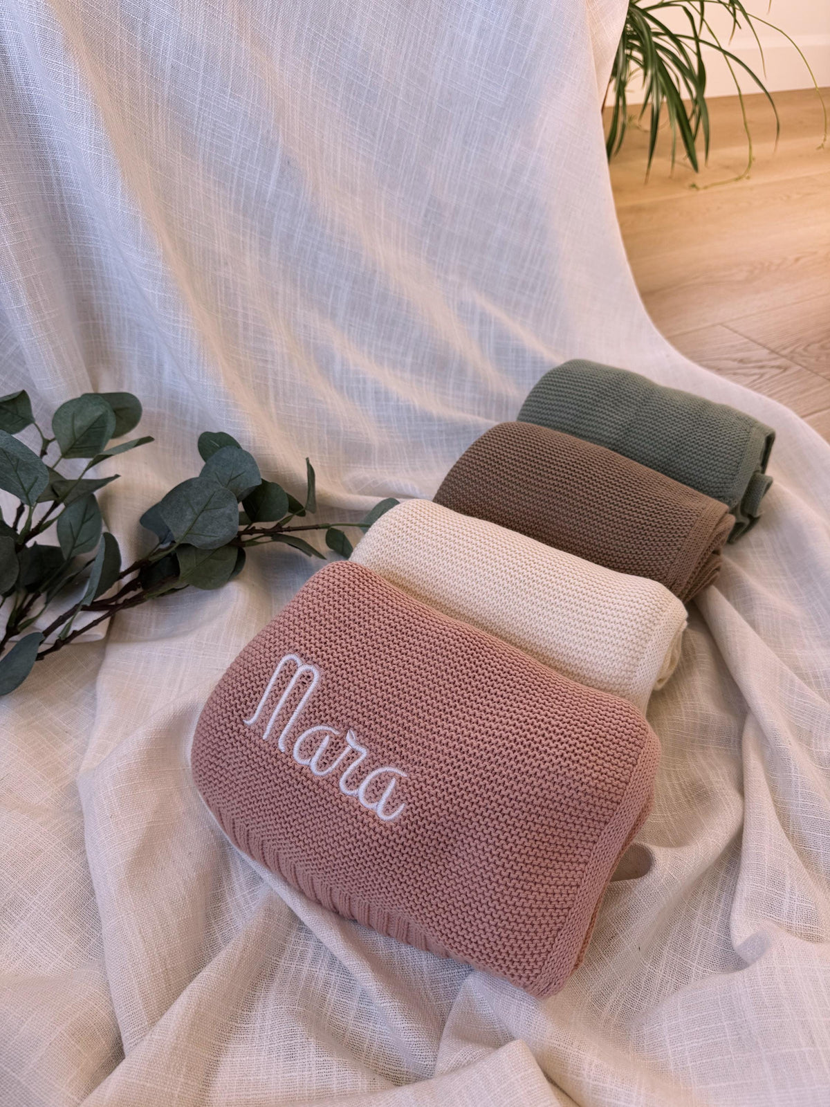 Embroidered name detail on an organic cotton baby blanket
